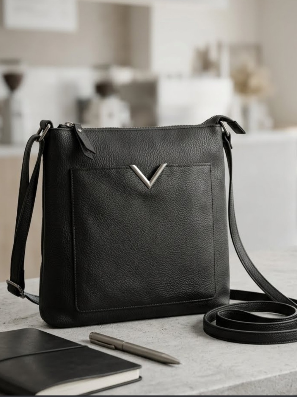 Atmosphere Black faux leather crossbody bag with a metallic V logo detail